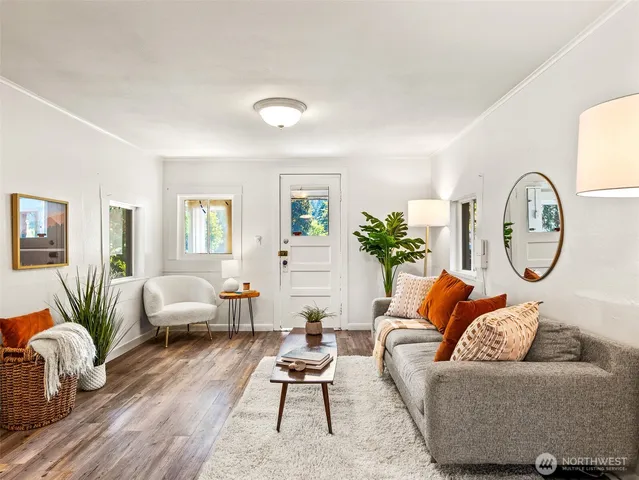 a living room with furniture and wooden floor