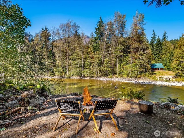 a view of a chairs and table in the backyard