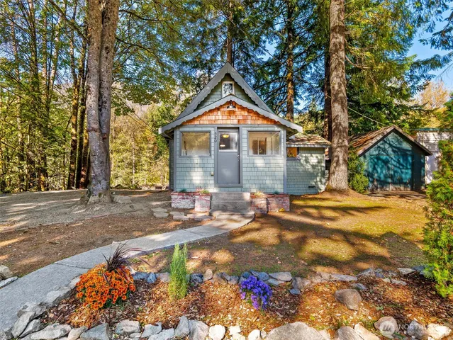 a living room with a couch swing table and chairs