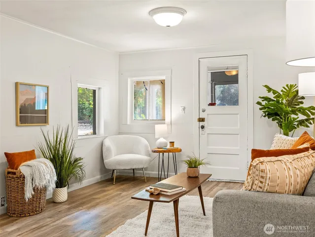 a living room with furniture and a chandelier