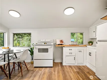 a kitchen with appliances cabinets and a window
