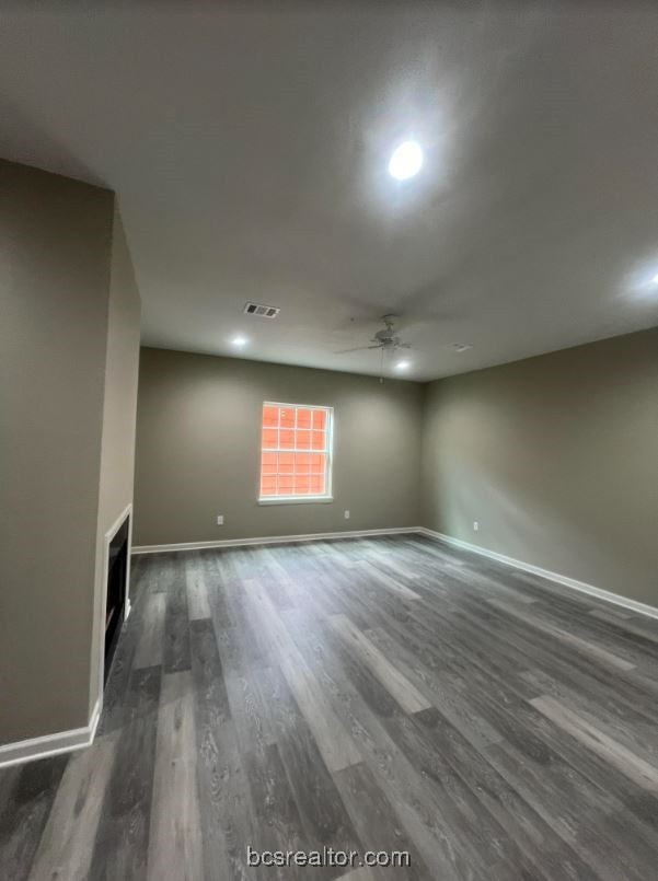 1305 West Villa Maria Road, Unit D105 Bryan, TX 77801 - Photo 3 of 20 an empty room with wooden floor and windows