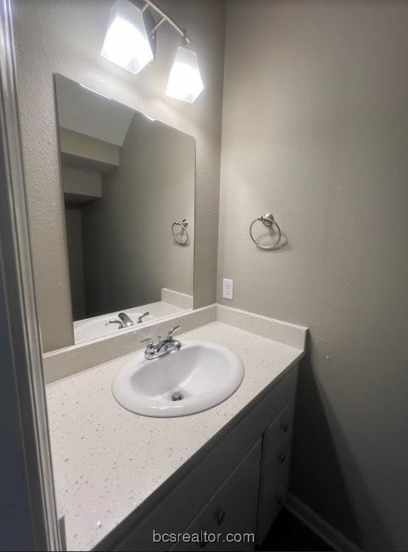 1305 West Villa Maria Road, Unit D105 Bryan, TX 77801 - Photo 5 of 20 a bathroom with a sink and a mirror