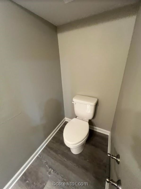 1305 West Villa Maria Road, Unit D105 Bryan, TX 77801 - Photo 7 of 20 a white toilet sitting next to a white wall