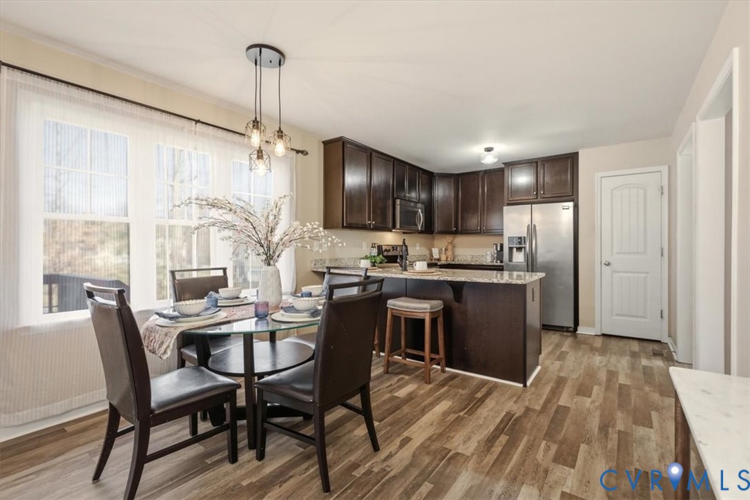 5312 Old Glory Road Chesterfield, VA 23832 - Photo 13 of 48 a kitchen with a table chairs refrigerator and cabinets