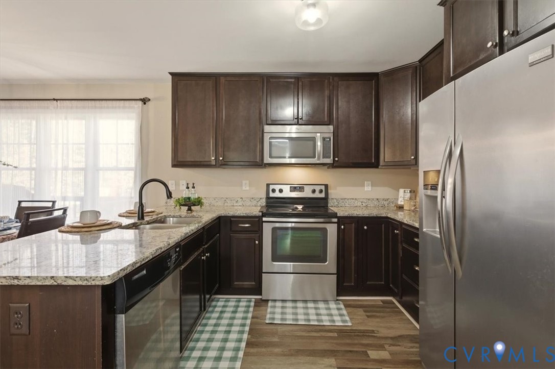 5312 Old Glory Road Chesterfield, VA 23832 - Photo 16 of 48 a kitchen with stainless steel appliances granite countertop a sink stove and refrigerator