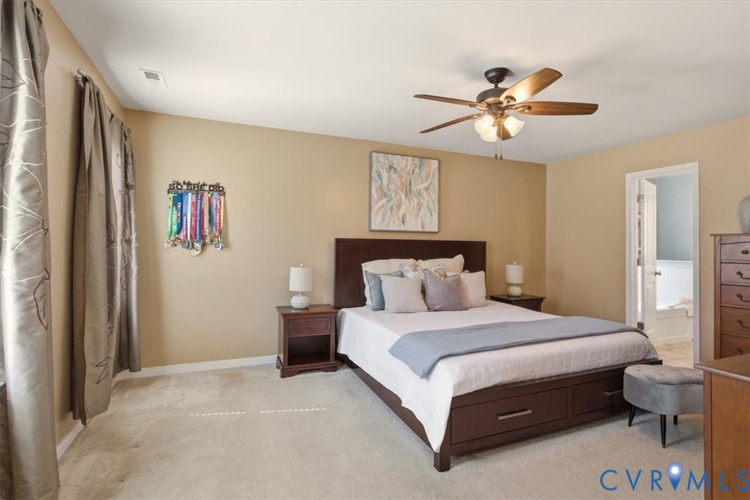 5312 Old Glory Road Chesterfield, VA 23832 - Photo 25 of 48 a bedroom with a bed and a chandelier