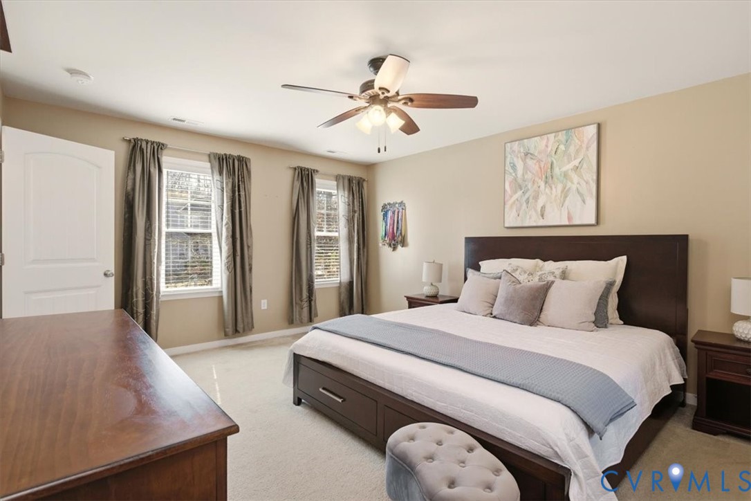 5312 Old Glory Road Chesterfield, VA 23832 - Photo 26 of 48 a spacious bedroom with a large bed and a chandelier