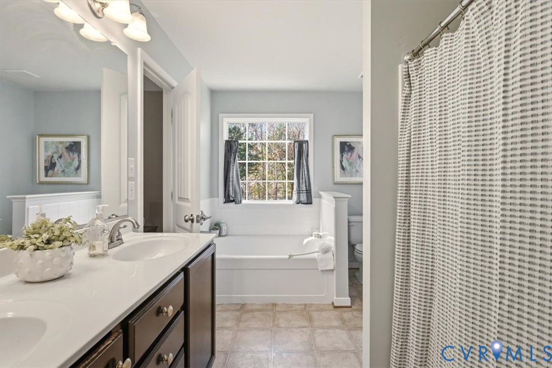 5312 Old Glory Road Chesterfield, VA 23832 - Photo 29 of 48 a bathroom with a sink a bathtub and a mirror