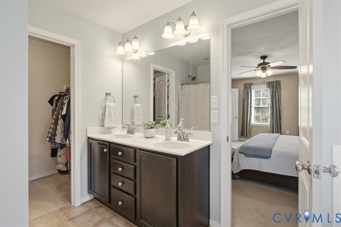 5312 Old Glory Road Chesterfield, VA 23832 - Photo 30 of 48 a en suite bathroom with a double vanity sink and a mirror