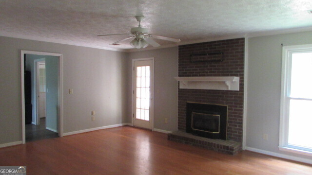 40 River Point Drive LaGrange, GA 30240 - Photo 13 of 17 wooden floor fireplace and windows in an empty room