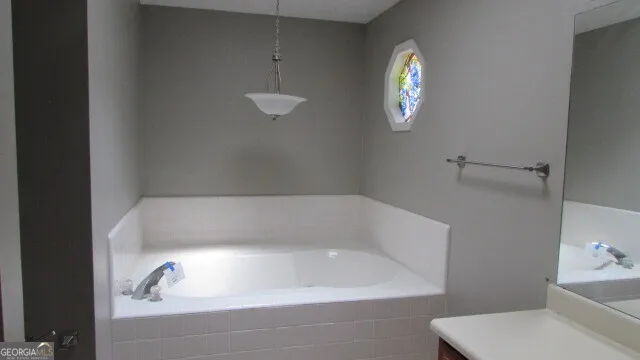 a bathroom with a bathtub and sink