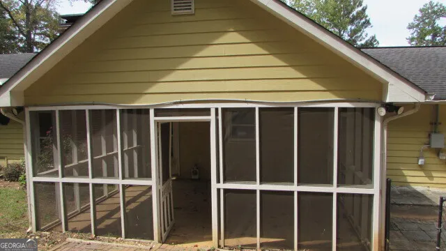 a back view of a house with a large window