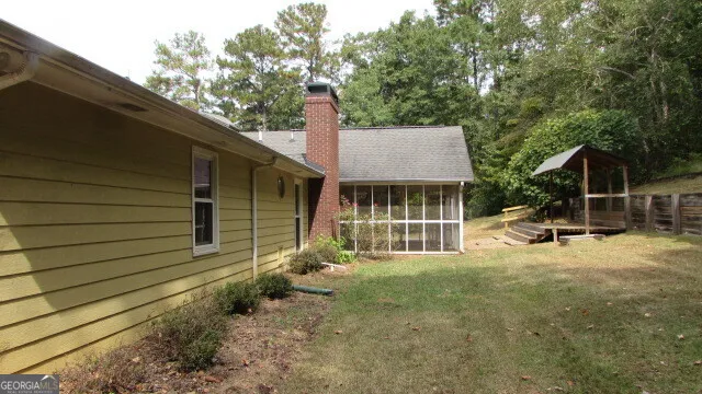 a view of a house with backyard and sitting area