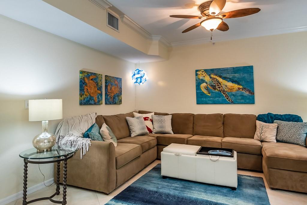 6944 West Sample Road, Unit 6944 Pompano Beach, FL 33063 - Photo 36 of 49 a living room with furniture and a lamp