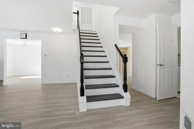 a view of a room with wooden floor and stairs