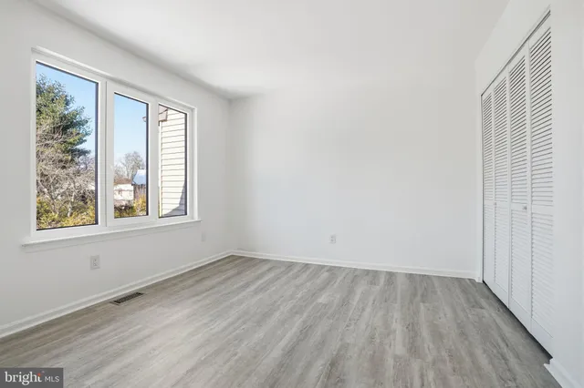 wooden floor in an empty room with a window