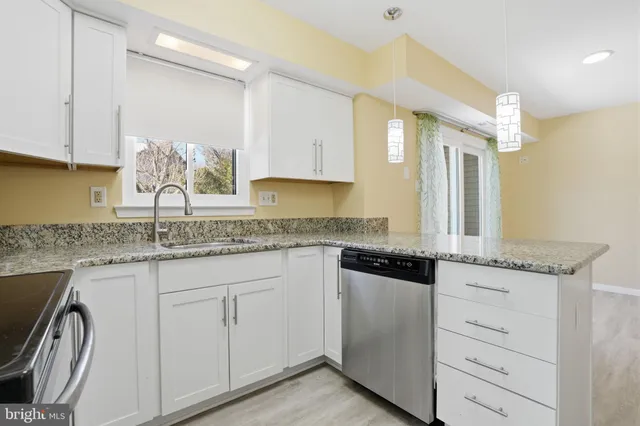 a kitchen with granite countertop cabinets and window
