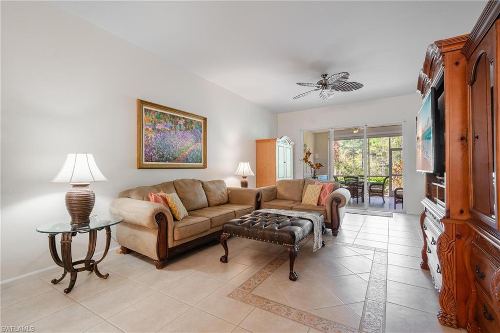 14565 Red Fox Run, Unit 613 Naples, FL 34110 - Photo 11 of 48 a living room with furniture and a lamp