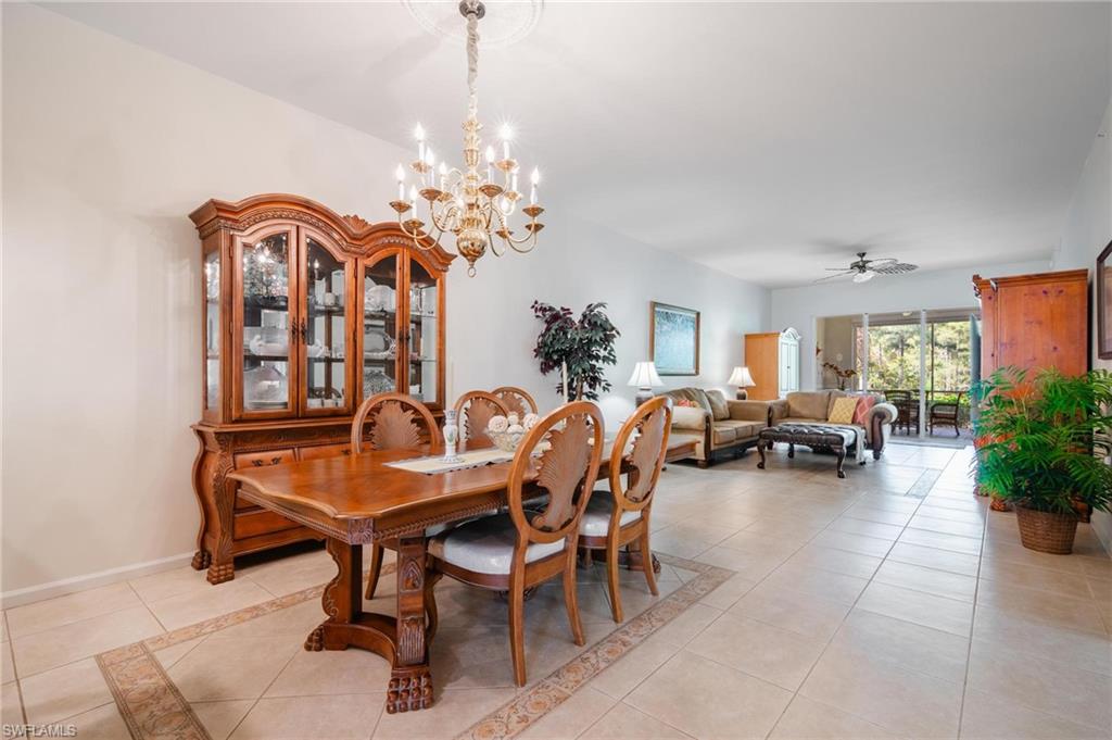 14565 Red Fox Run, Unit 613 Naples, FL 34110 - Photo 12 of 48 a view of a dining room and livingroom with furniture wooden floor a chandelier