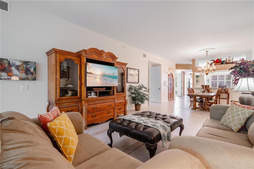 14565 Red Fox Run, Unit 613 Naples, FL 34110 - Photo 15 of 48 a living room with furniture and a flat screen tv