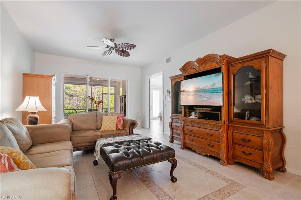 14565 Red Fox Run, Unit 613 Naples, FL 34110 - Photo 16 of 48 a living room with furniture and a flat screen tv