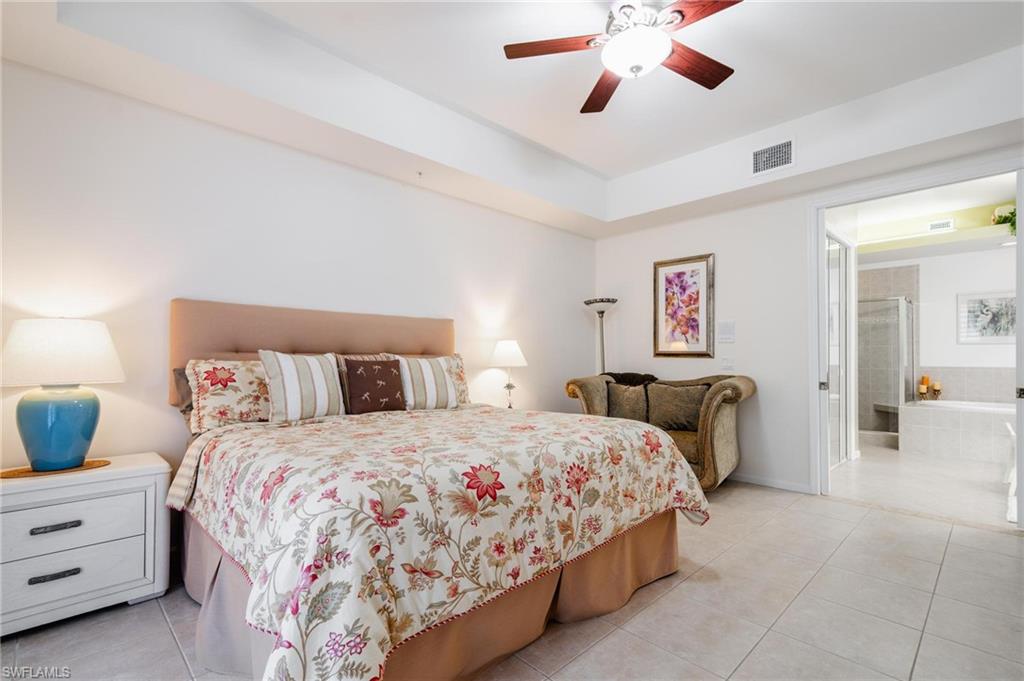 14565 Red Fox Run, Unit 613 Naples, FL 34110 - Photo 18 of 48 a bedroom with a bed and ceiling fan