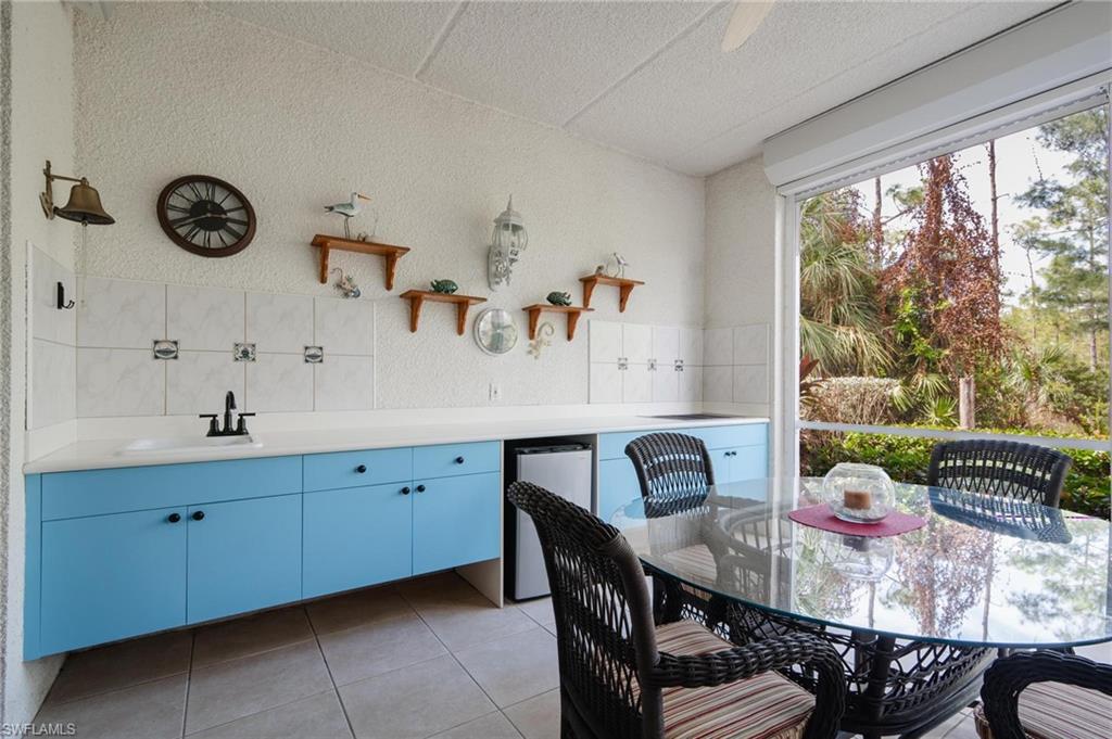 14565 Red Fox Run, Unit 613 Naples, FL 34110 - Photo 2 of 48 a view of a dining room with a table and chairs