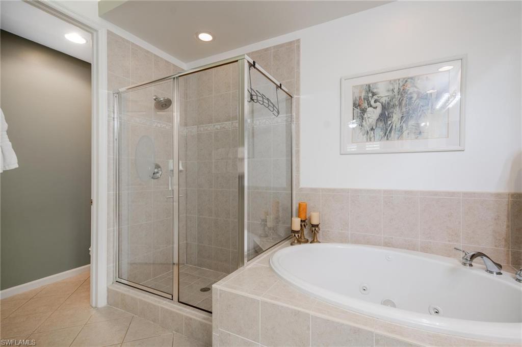 14565 Red Fox Run, Unit 613 Naples, FL 34110 - Photo 21 of 48 a white bath tub sitting next to a bathroom