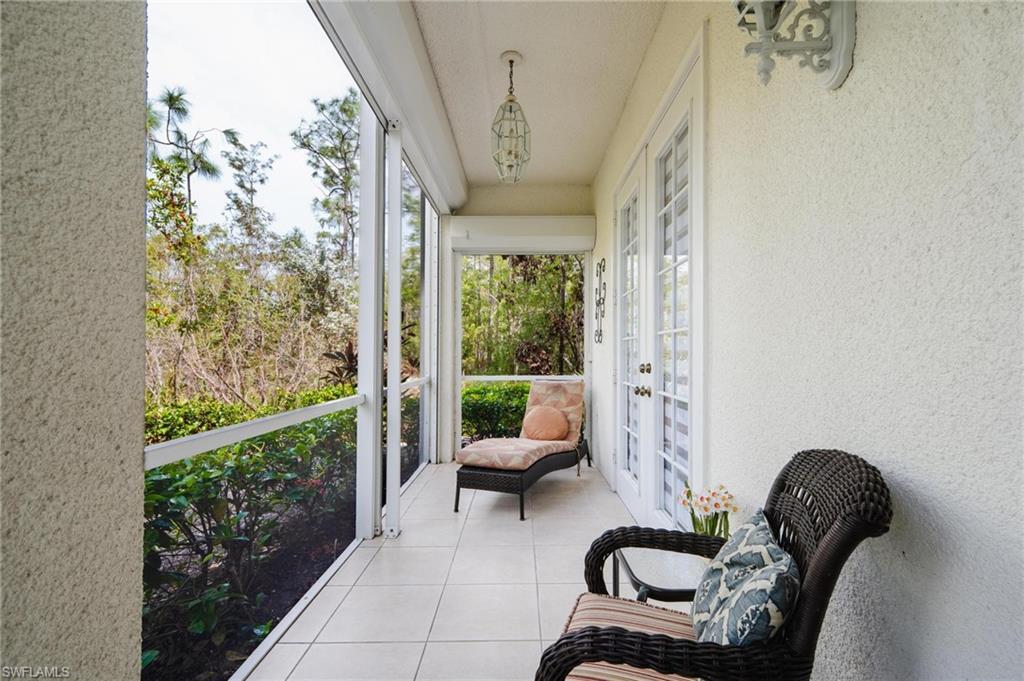 14565 Red Fox Run, Unit 613 Naples, FL 34110 - Photo 23 of 48 a living room with furniture and a large window