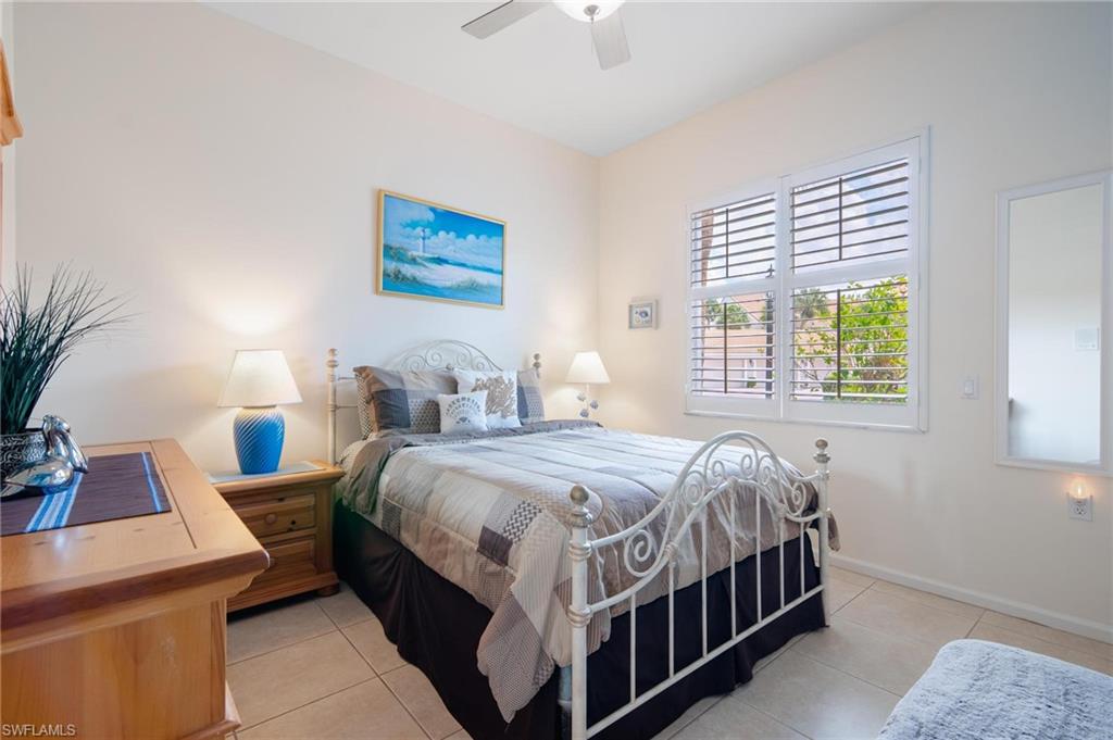 14565 Red Fox Run, Unit 613 Naples, FL 34110 - Photo 25 of 48 a bedroom with bed and a window