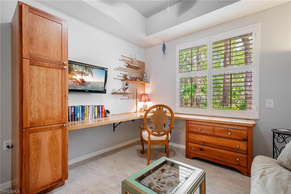 14565 Red Fox Run, Unit 613 Naples, FL 34110 - Photo 31 of 48 a living room with furniture and a flat screen tv