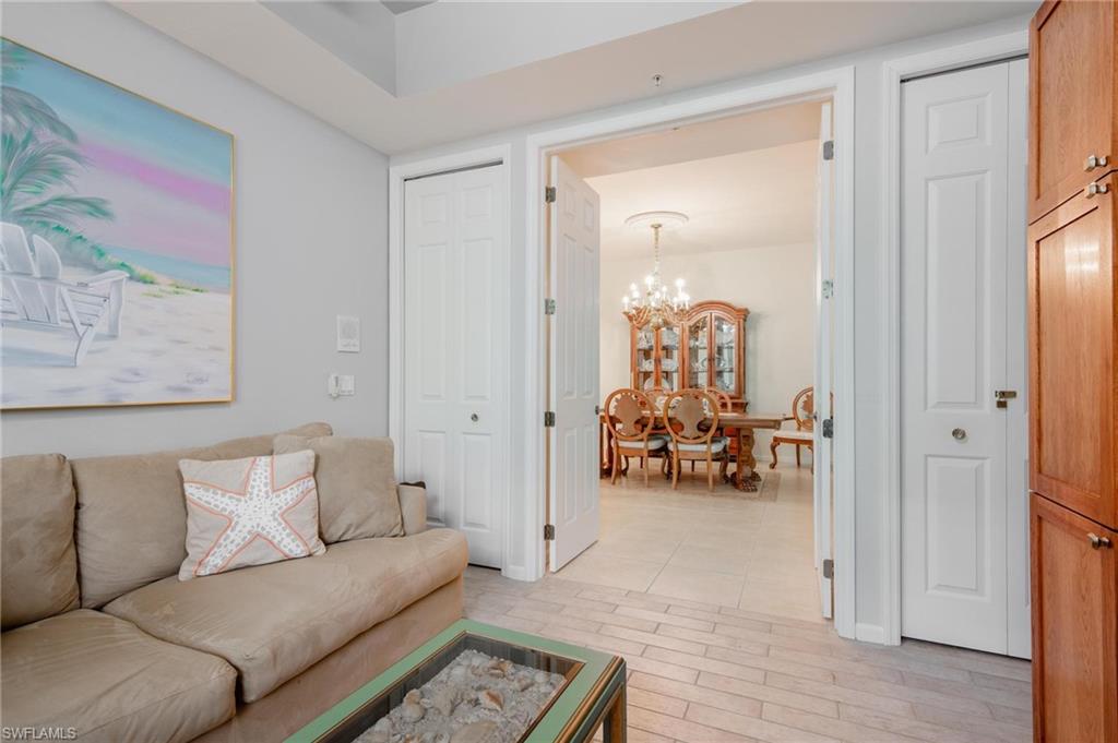 14565 Red Fox Run, Unit 613 Naples, FL 34110 - Photo 32 of 48 a living room with furniture and a chandelier