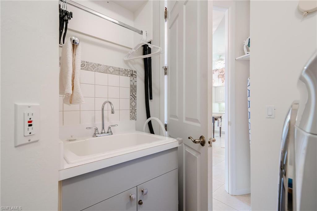 14565 Red Fox Run, Unit 613 Naples, FL 34110 - Photo 33 of 48 a bathroom with a sink and a mirror