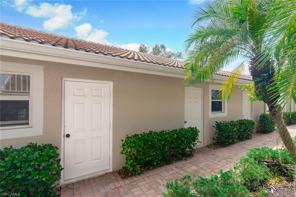 14565 Red Fox Run, Unit 613 Naples, FL 34110 - Photo 37 of 48 a front view of a house with garden