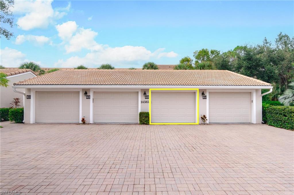 14565 Red Fox Run, Unit 613 Naples, FL 34110 - Photo 39 of 48 front view of a house with a garage