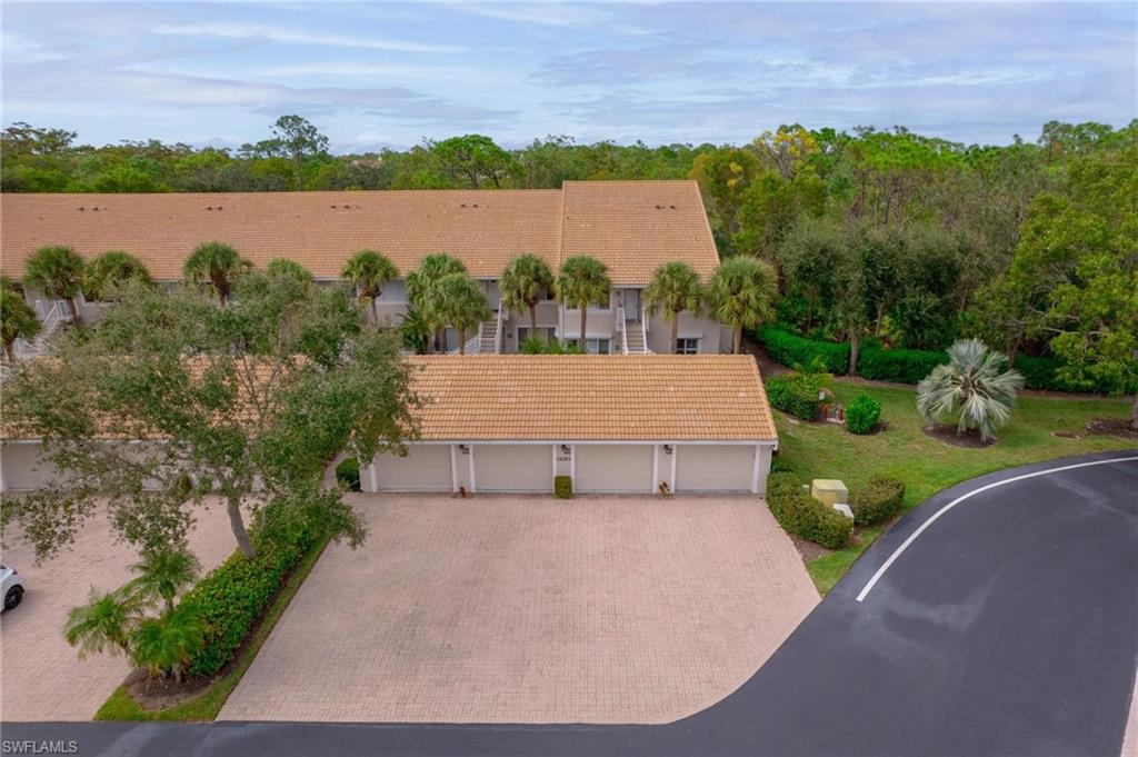 14565 Red Fox Run, Unit 613 Naples, FL 34110 - Photo 41 of 48 an aerial view of a house with a garden and lake view