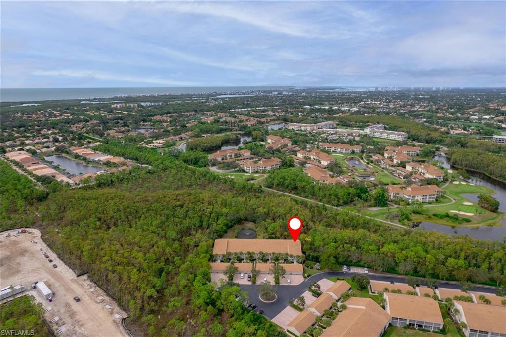 14565 Red Fox Run, Unit 613 Naples, FL 34110 - Photo 43 of 48 an aerial view of a city with lots of residential buildings