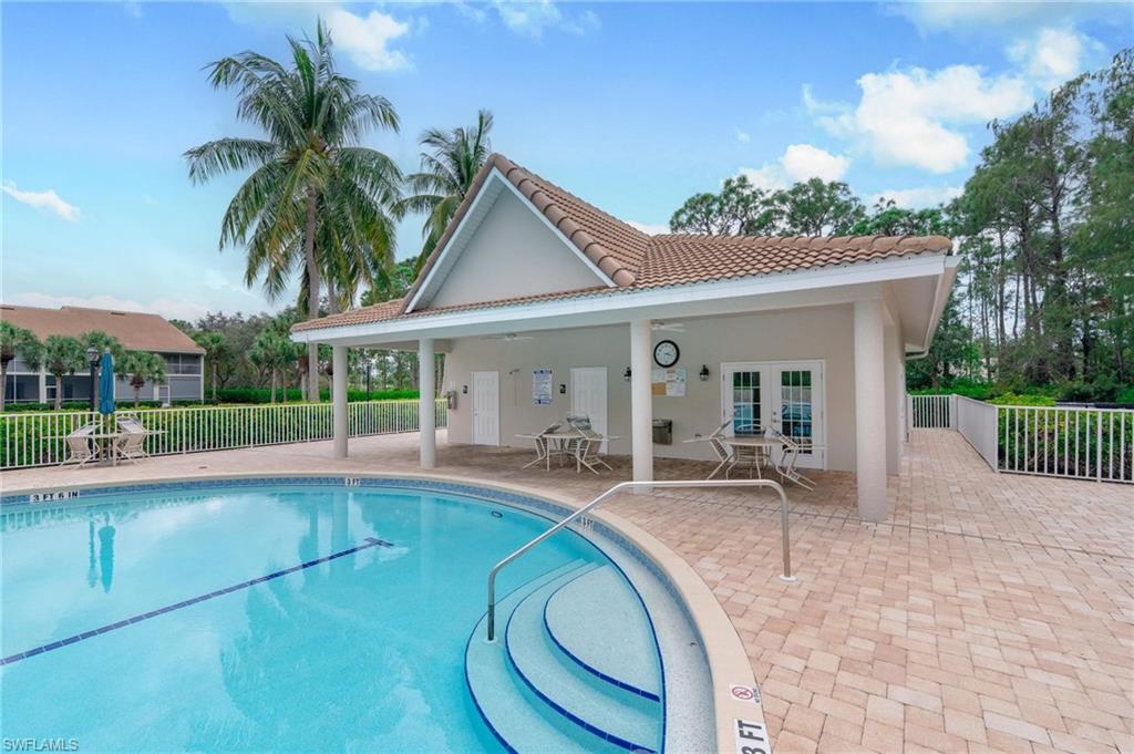 14565 Red Fox Run, Unit 613 Naples, FL 34110 - Photo 46 of 48 a view of a house with a swimming pool and a porch