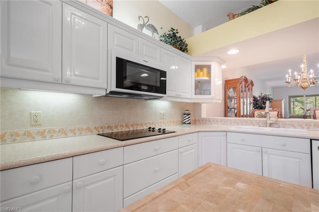 14565 Red Fox Run, Unit 613 Naples, FL 34110 - Photo 6 of 48 a kitchen with appliances a sink and cabinets