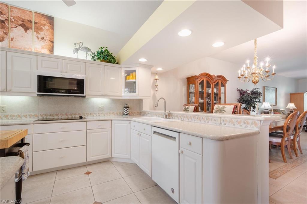 14565 Red Fox Run, Unit 613 Naples, FL 34110 - Photo 9 of 48 a kitchen with stainless steel appliances granite countertop a sink and cabinets