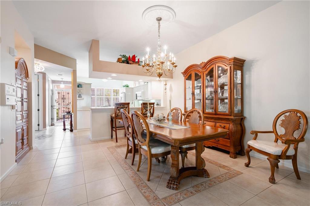 14565 Red Fox Run, Unit 613 Naples, FL 34110 - Photo 10 of 48 a view of a dining room and hall with furniture