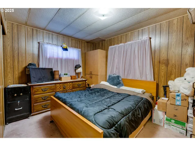 a bedroom with a bed and a mirror