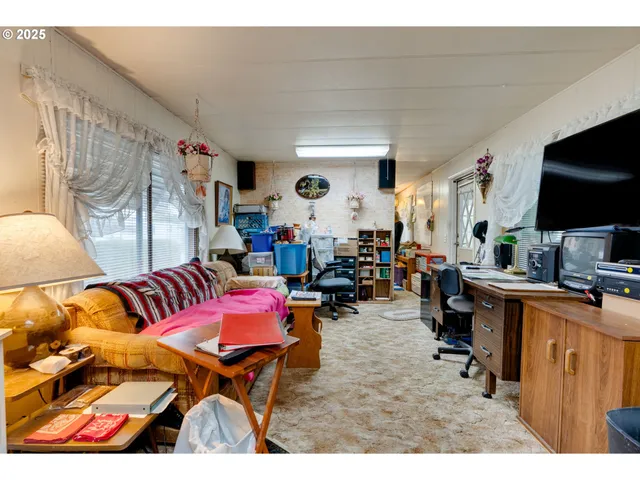 a living room filled with furniture and a flat screen tv