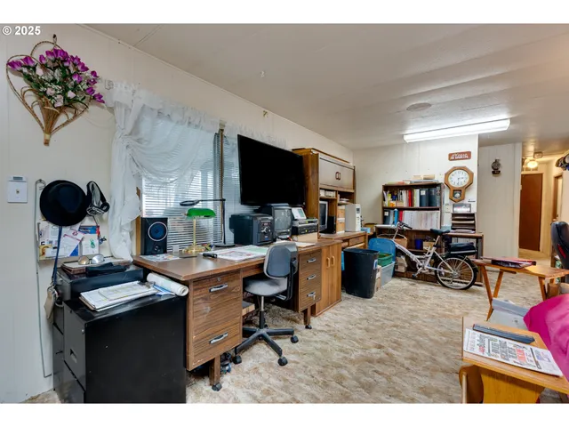 a view of a livingroom with workspace and a couch