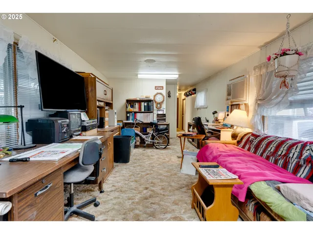 a bedroom with furniture and a flat screen tv