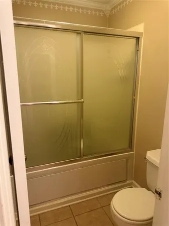 a bathroom with a toilet and a shower