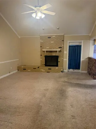 a view of an empty room with a fireplace