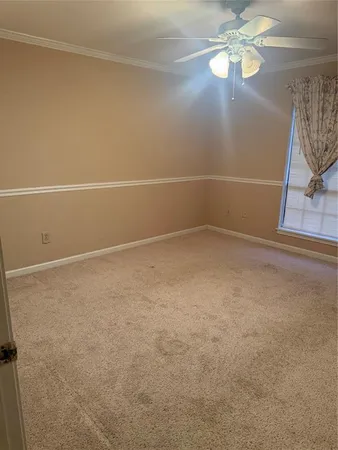 a view of an empty room with a fan