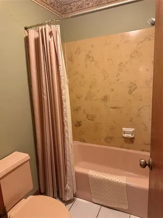 a bathroom with a toilet and a bathtub